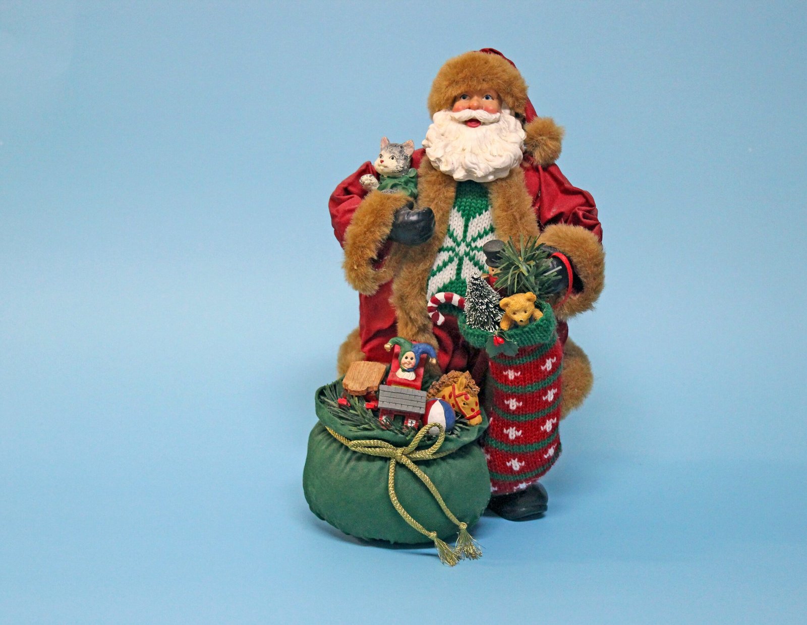 brown bear in red and brown coat figurine